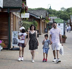 Image shows a family of four enjoying a day of shopping at Trentham